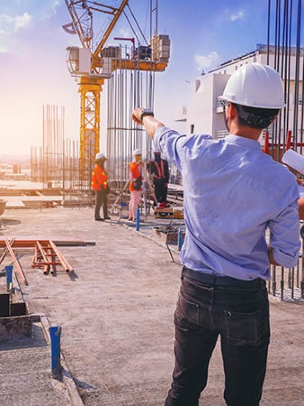 Smart civil architect engineer inspecting and working outdoors structure building site with blueprints. engineering and architecture concept.